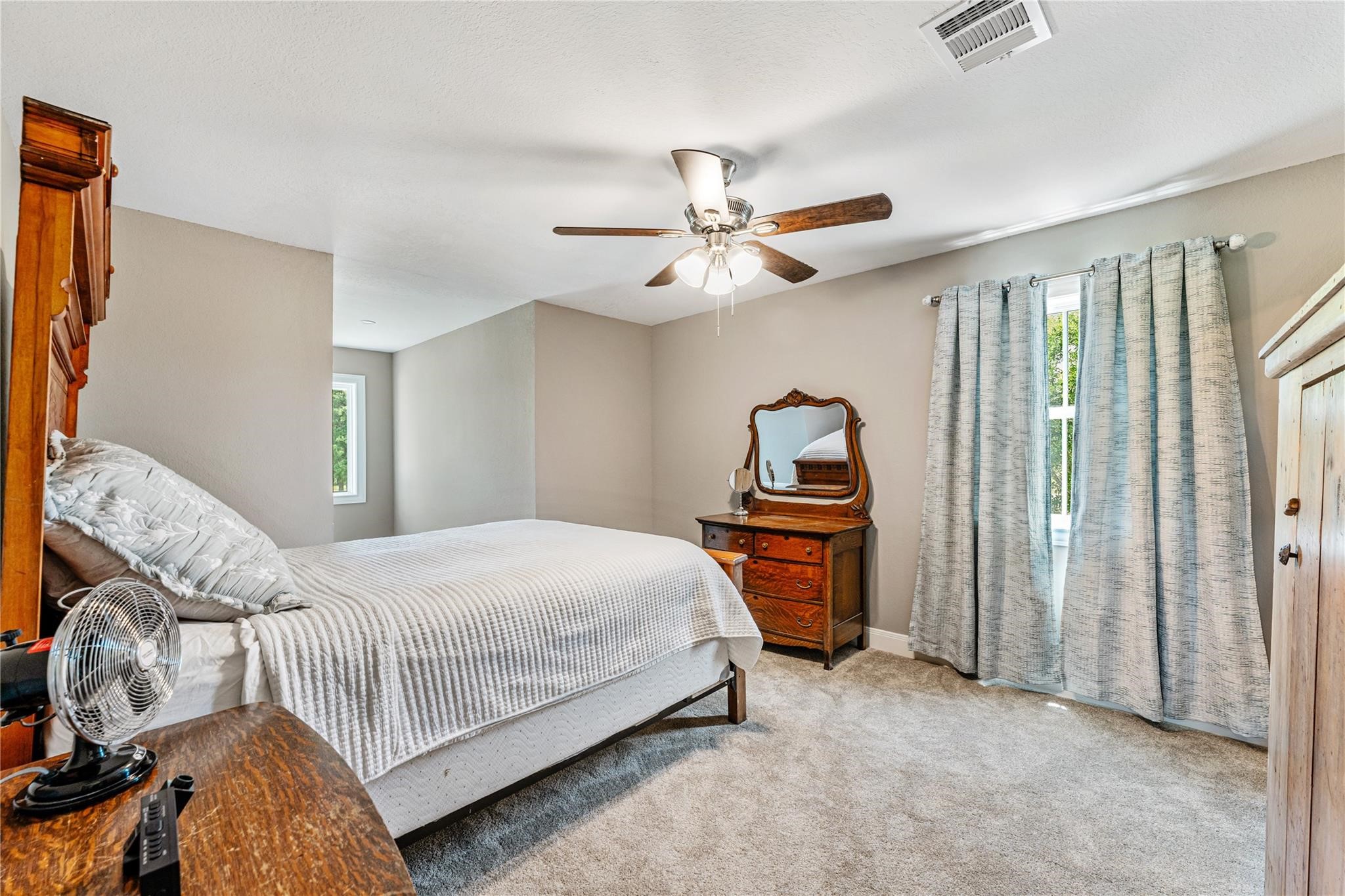 6063 Fm 1094 Sealy, TX 77474 - Photo 36 of 47 a bedroom with a bed and a chandelier