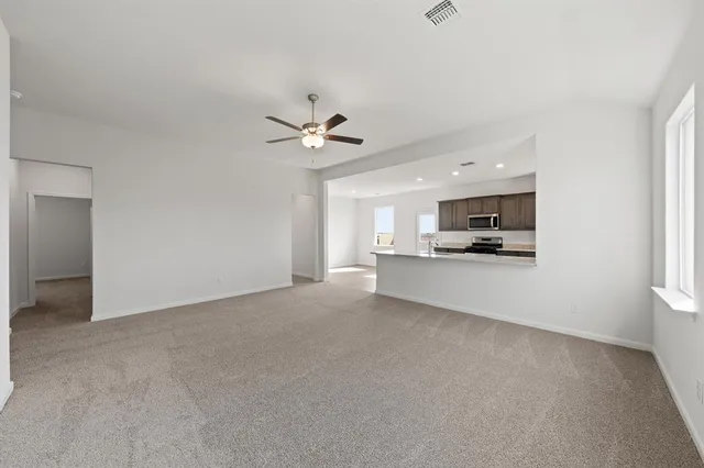 a view of a kitchen with a sink and a stove top oven