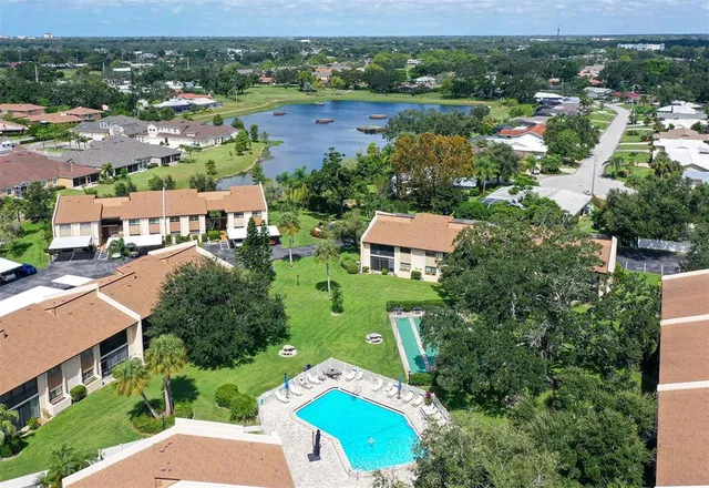an aerial view of residential houses with outdoor space and river