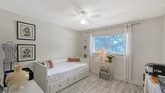 a view of a workspace with furniture and wooden floor