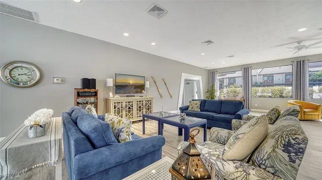 a living room with furniture and a floor to ceiling window