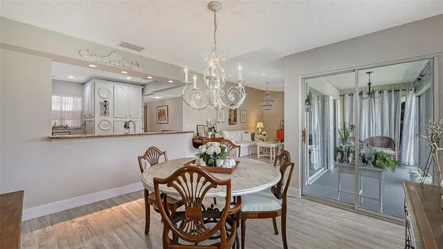 a view of a dining room with furniture and chandelier