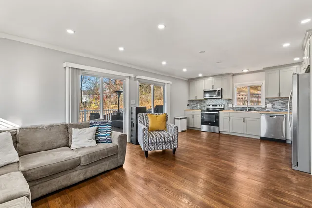 a living room with furniture and kitchen view