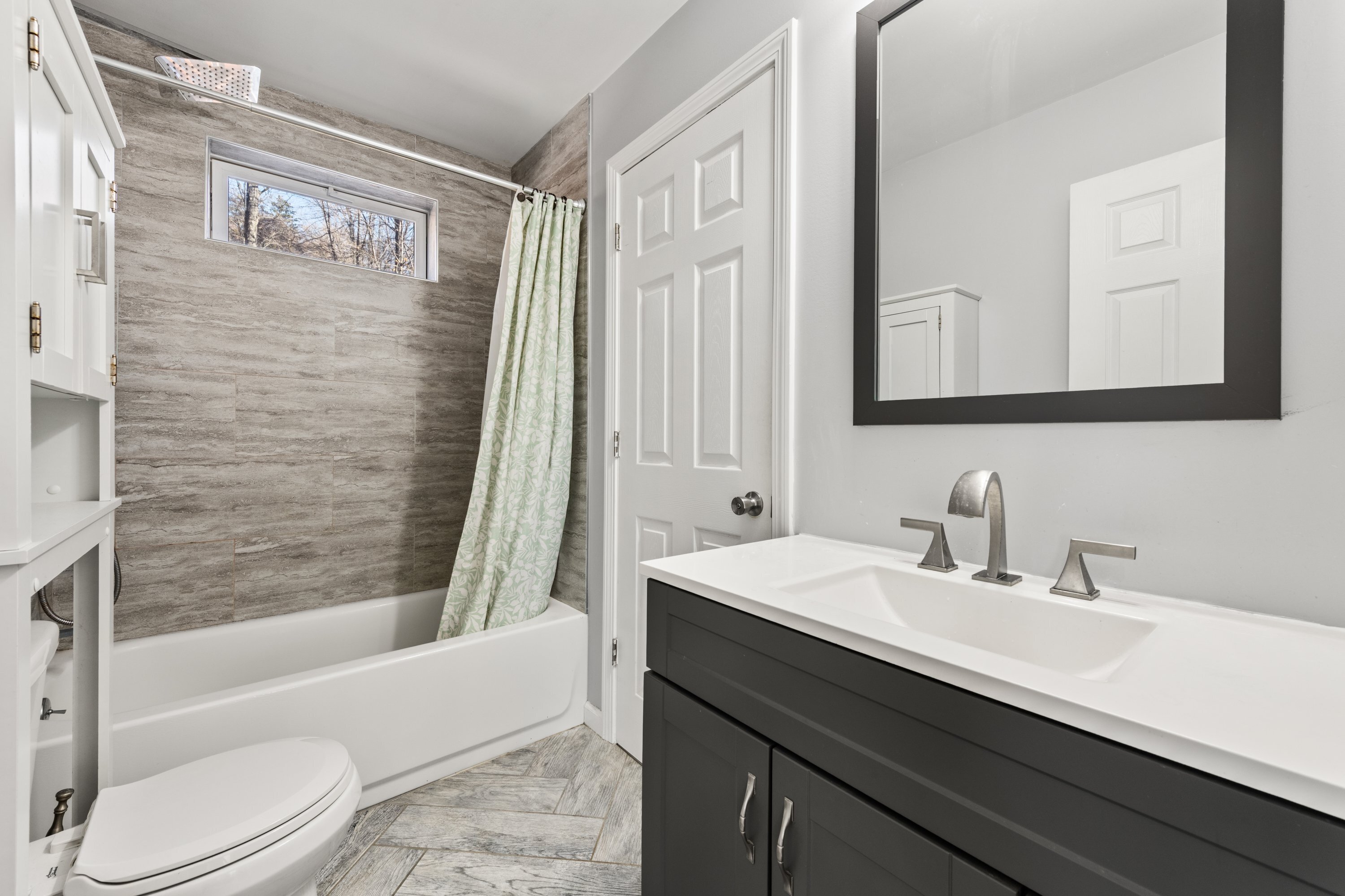 3 Highland Avenue Ansonia, CT 06401 - Photo 22 of 38 a bathroom with a sink a toilet a mirror a bathtub and shower