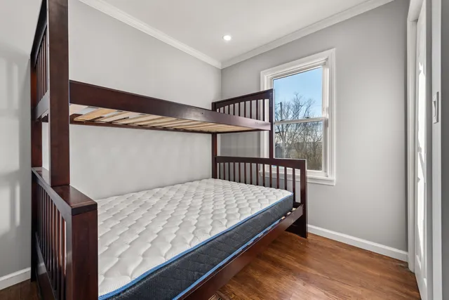 a view of bedroom with wooden floor