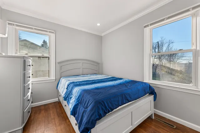 a bedroom with a bed and glass window