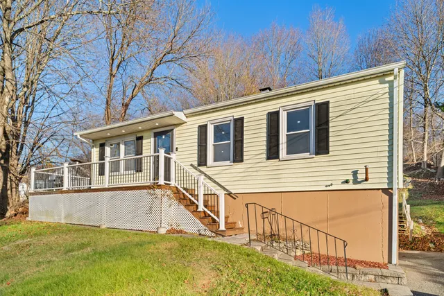 a view of a house with pool and wooden fence