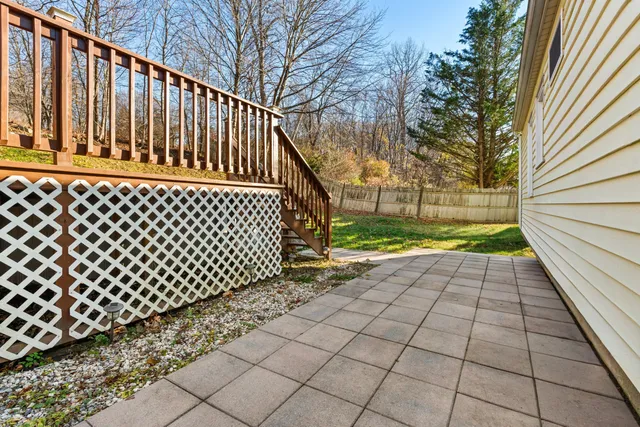 a view of backyard with wooden fence