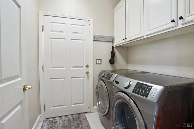 a view of storage and utility room with washer and dryer