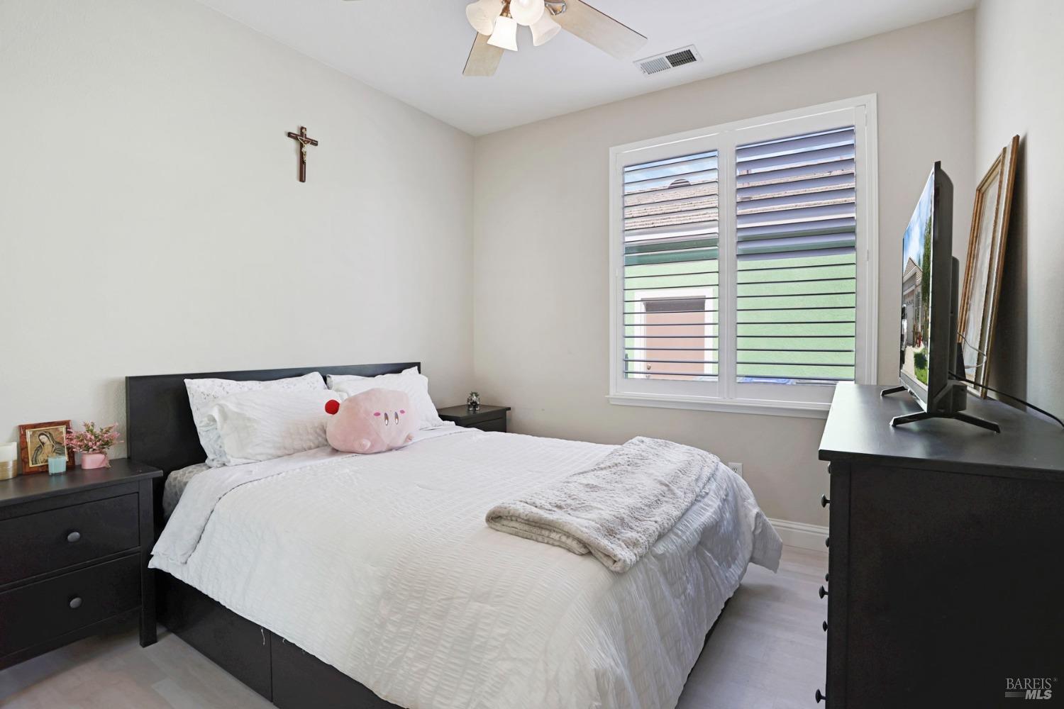 234 Cedar Ridge Drive Rio Vista, CA 94571 - Photo 25 of 33 a bedroom with a bed lamps and a large mirror on the dresser