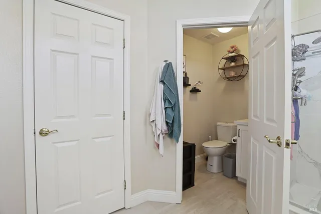 a bathroom with a toilet and a shower