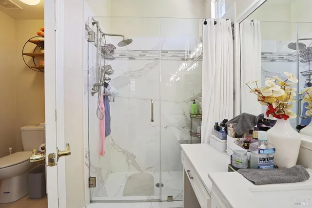 a bathroom with a tub shower sink and toilet