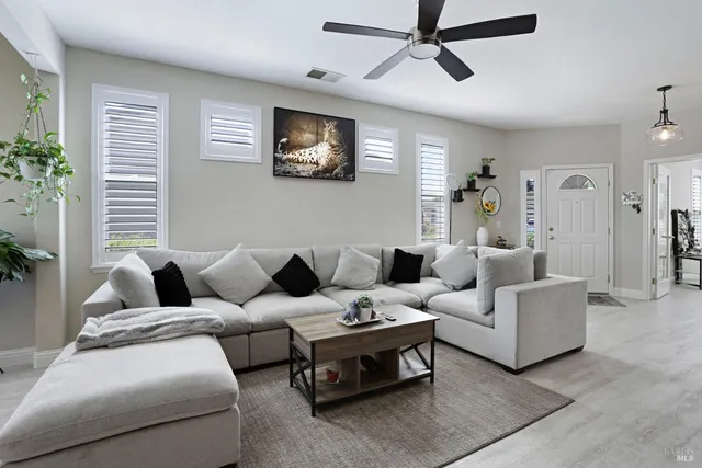 a living room with furniture and a large window