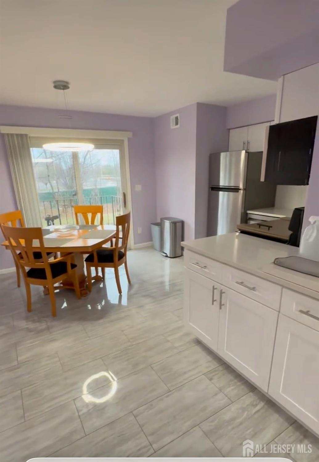 a kitchen with kitchen island granite countertop a stove a sink and a dining table