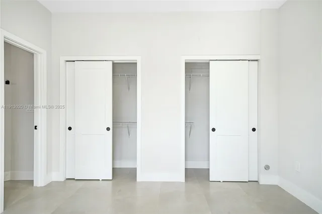 a bathroom with a granite countertop sink a mirror and shower