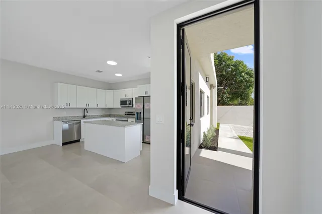 a kitchen with white cabinets and white appliances