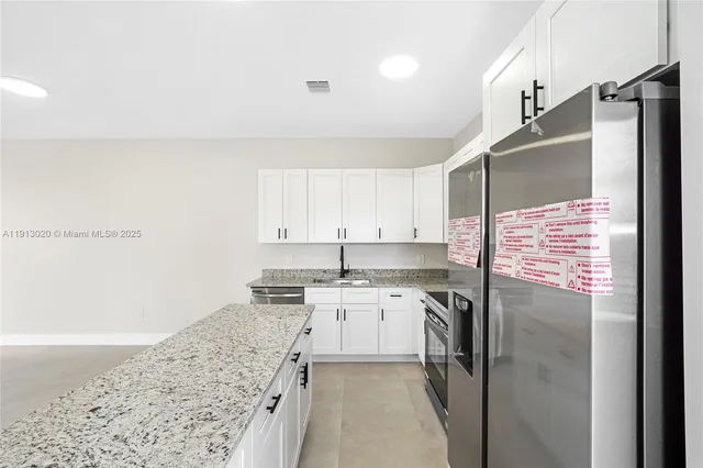 a kitchen with a sink stove and refrigerator