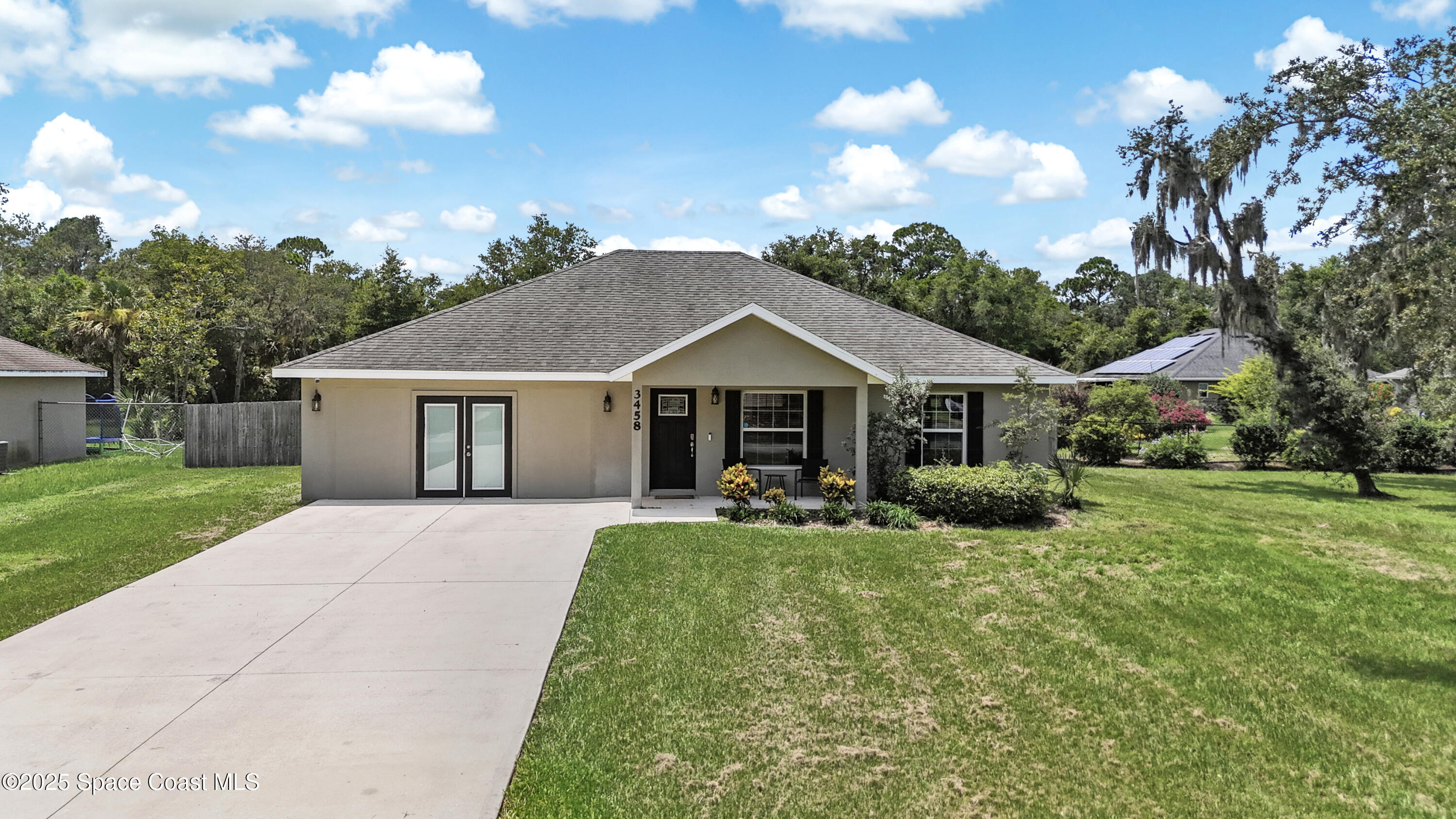 a front view of house with yard and green space