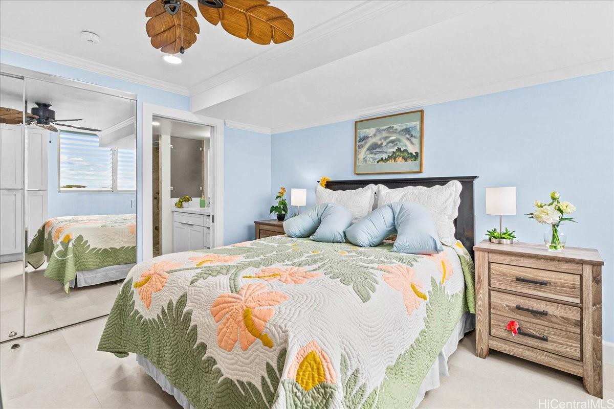 3215 Ala Ilima Street, Unit A/PH2 Honolulu, HI 96818 - Photo 11 of 25 a bedroom with a bed and a chandelier