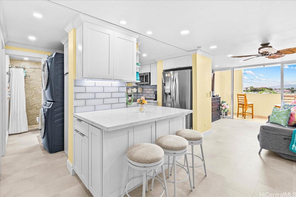 3215 Ala Ilima Street, Unit A/PH2 Honolulu, HI 96818 - Photo 14 of 25 a kitchen with stainless steel appliances granite countertop a kitchen island a stove a refrigerator and a sink