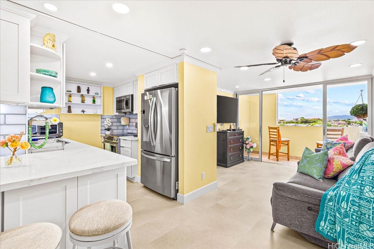3215 Ala Ilima Street, Unit A/PH2 Honolulu, HI 96818 - Photo 2 of 25 a kitchen with stainless steel appliances a refrigerator and a couch