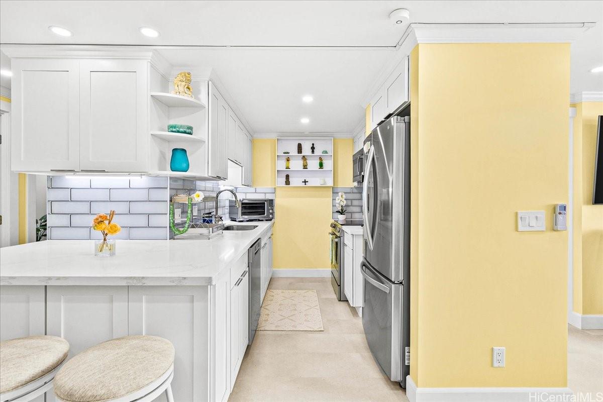 3215 Ala Ilima Street, Unit A/PH2 Honolulu, HI 96818 - Photo 3 of 25 a kitchen with a refrigerator and countertop