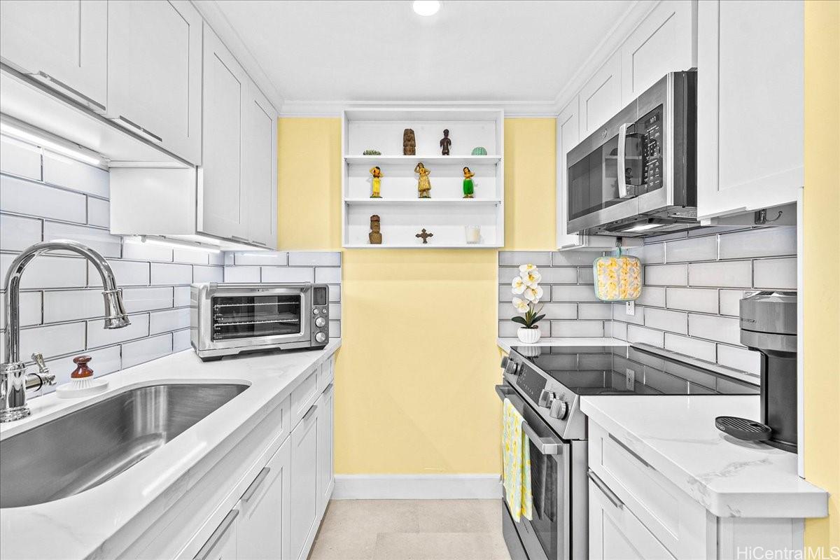 3215 Ala Ilima Street, Unit A/PH2 Honolulu, HI 96818 - Photo 5 of 25 a kitchen with granite countertop a sink a stove and refrigerator