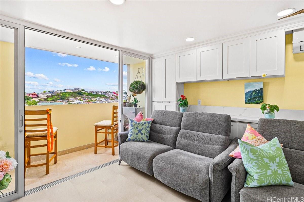 3215 Ala Ilima Street, Unit A/PH2 Honolulu, HI 96818 - Photo 9 of 25 a living room with furniture and a floor to ceiling window