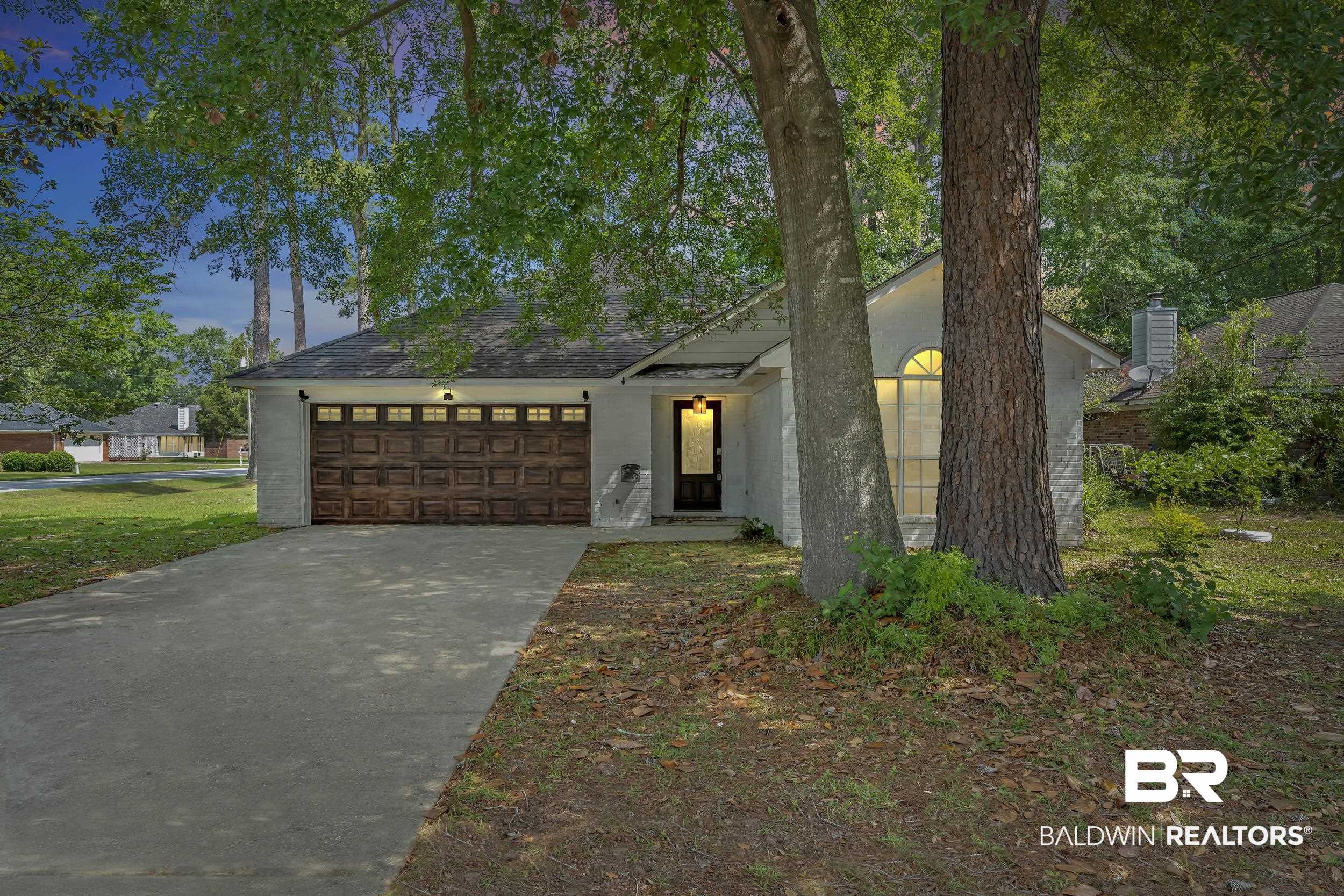 509 Loblolly Court Foley, AL 36535 - Photo 23 of 26 Single-story residence featuring a wood-finish garage door with window inserts, a concrete driveway, and a covered entry