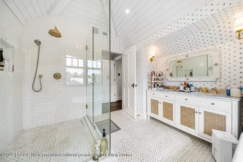 a bathroom with a granite countertop sink toilet and mirror