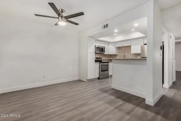 a kitchen with stainless steel appliances granite countertop a sink stove and microwave