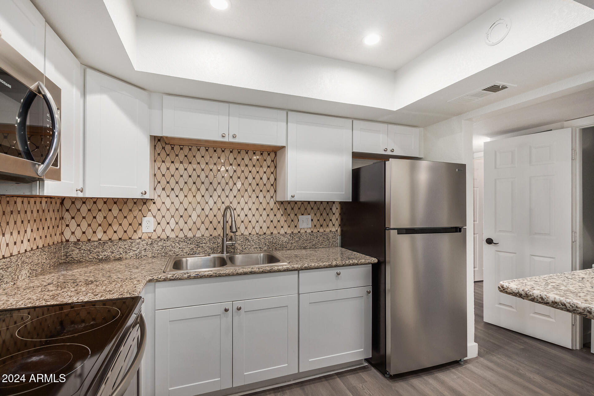 18202 Cave Creek Road, Unit 141 Phoenix, AZ 85032 - Photo 7 of 13 a kitchen with a refrigerator sink and cabinets