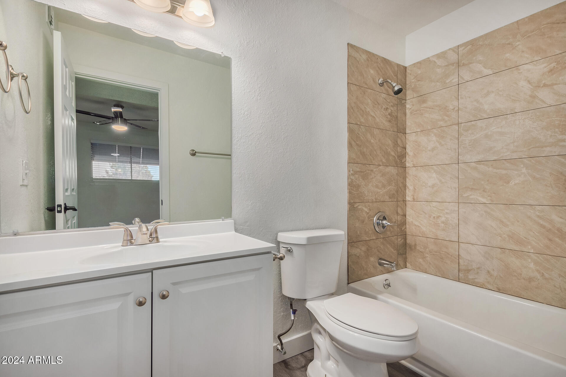 18202 Cave Creek Road, Unit 141 Phoenix, AZ 85032 - Photo 9 of 13 a bathroom with a sink toilet vanity and shower