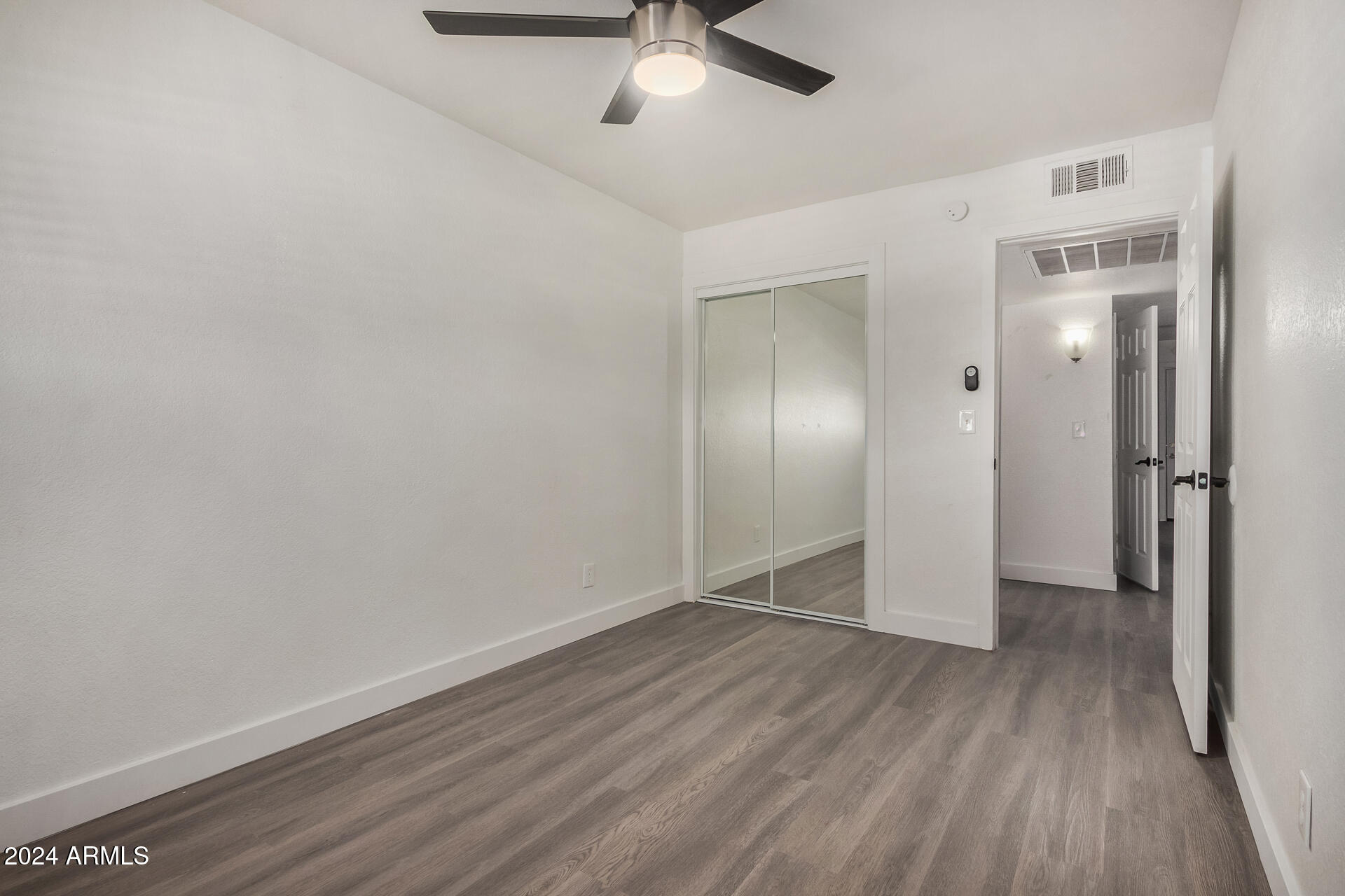 18202 Cave Creek Road, Unit 141 Phoenix, AZ 85032 - Photo 10 of 13 wooden floor in an empty room with a window