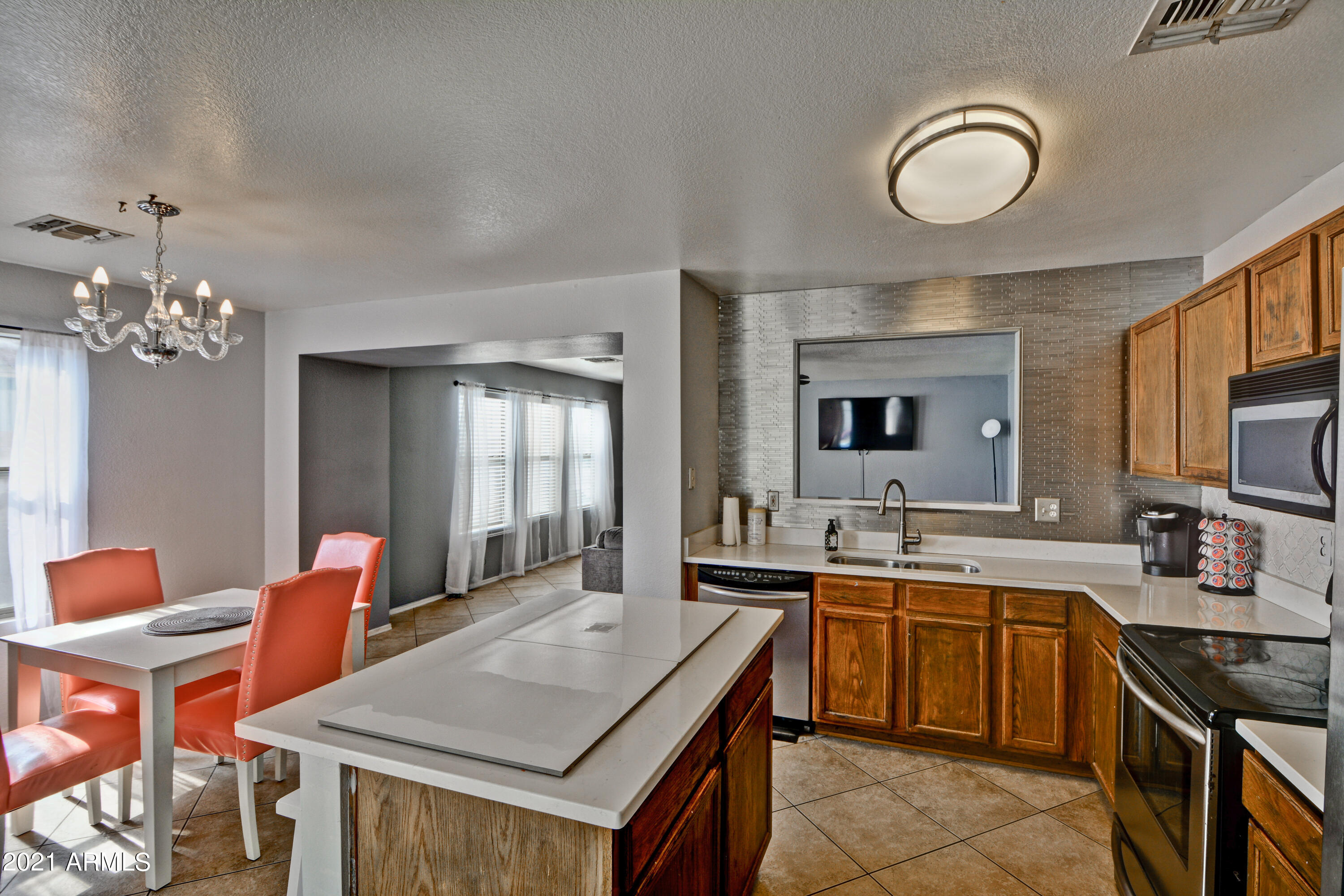 7945 West Hatcher Road Peoria, AZ 85345 - Photo 6 of 15 a kitchen with a table and chairs in it