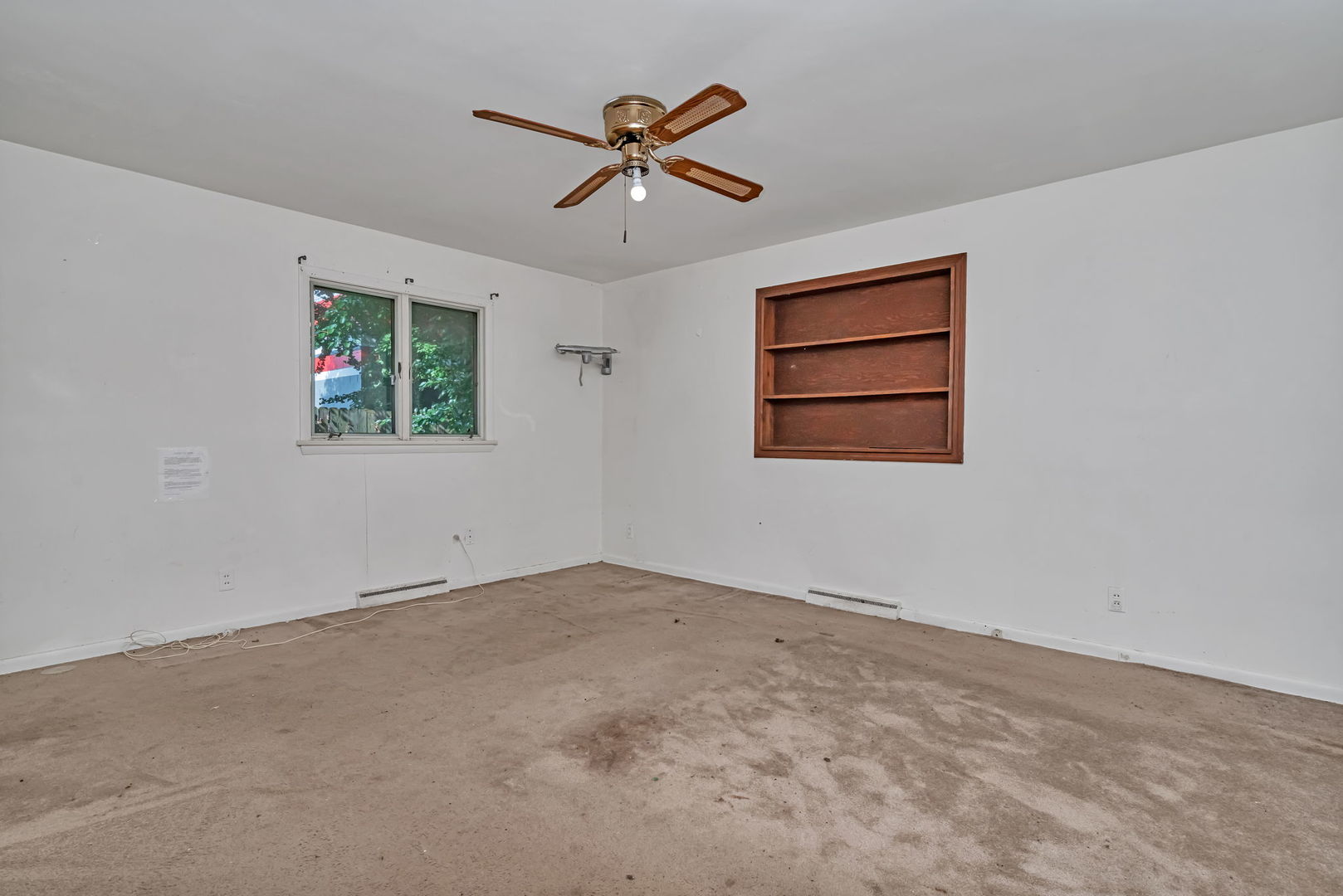 1108 East 9th Street Lockport, IL 60441 - Photo 12 of 22 an empty room with a ceiling fan and window
