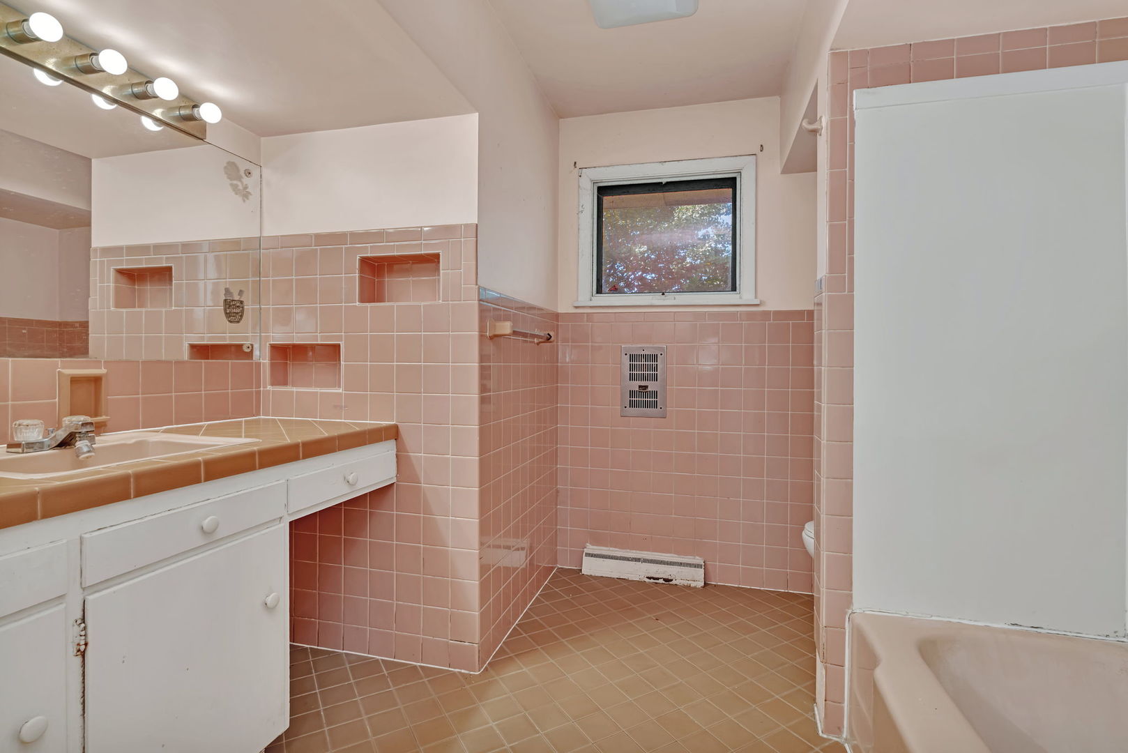1108 East 9th Street Lockport, IL 60441 - Photo 13 of 22 a bathroom with a sink a mirror a vanity and shower