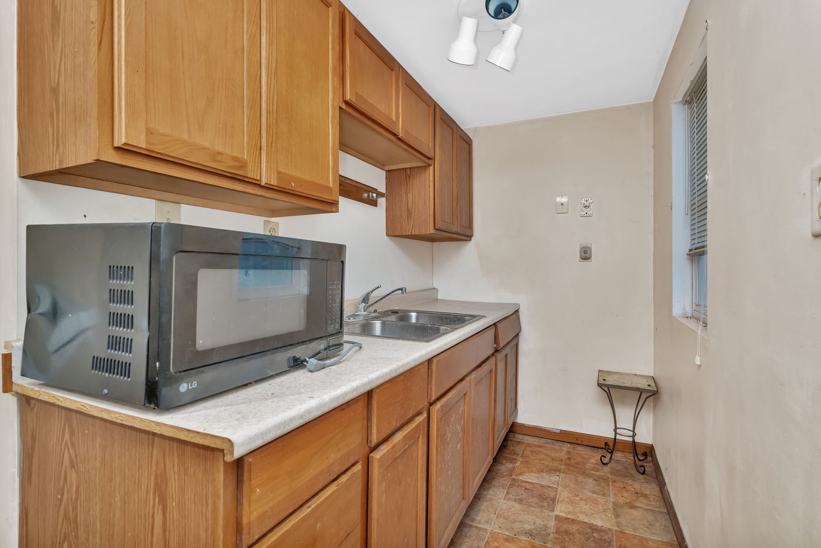 1108 East 9th Street Lockport, IL 60441 - Photo 18 of 22 a kitchen with stainless steel appliances granite countertop a sink and a microwave