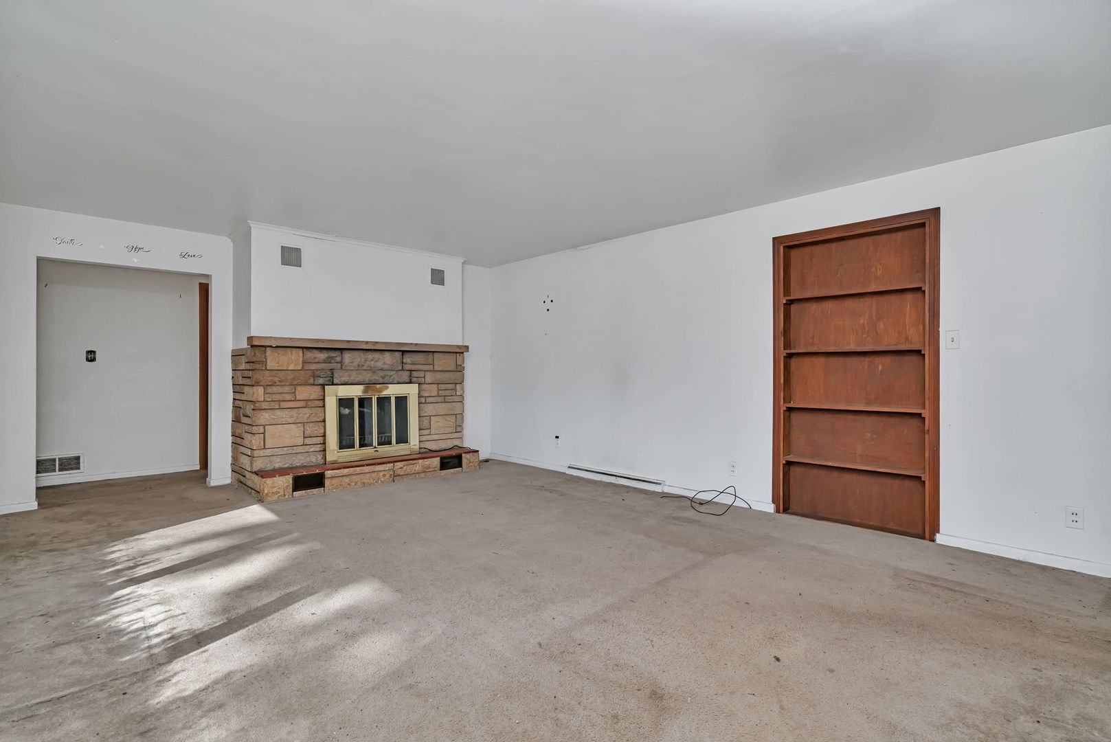1108 East 9th Street Lockport, IL 60441 - Photo 2 of 22 a view of an empty room with a fireplace and cabinet