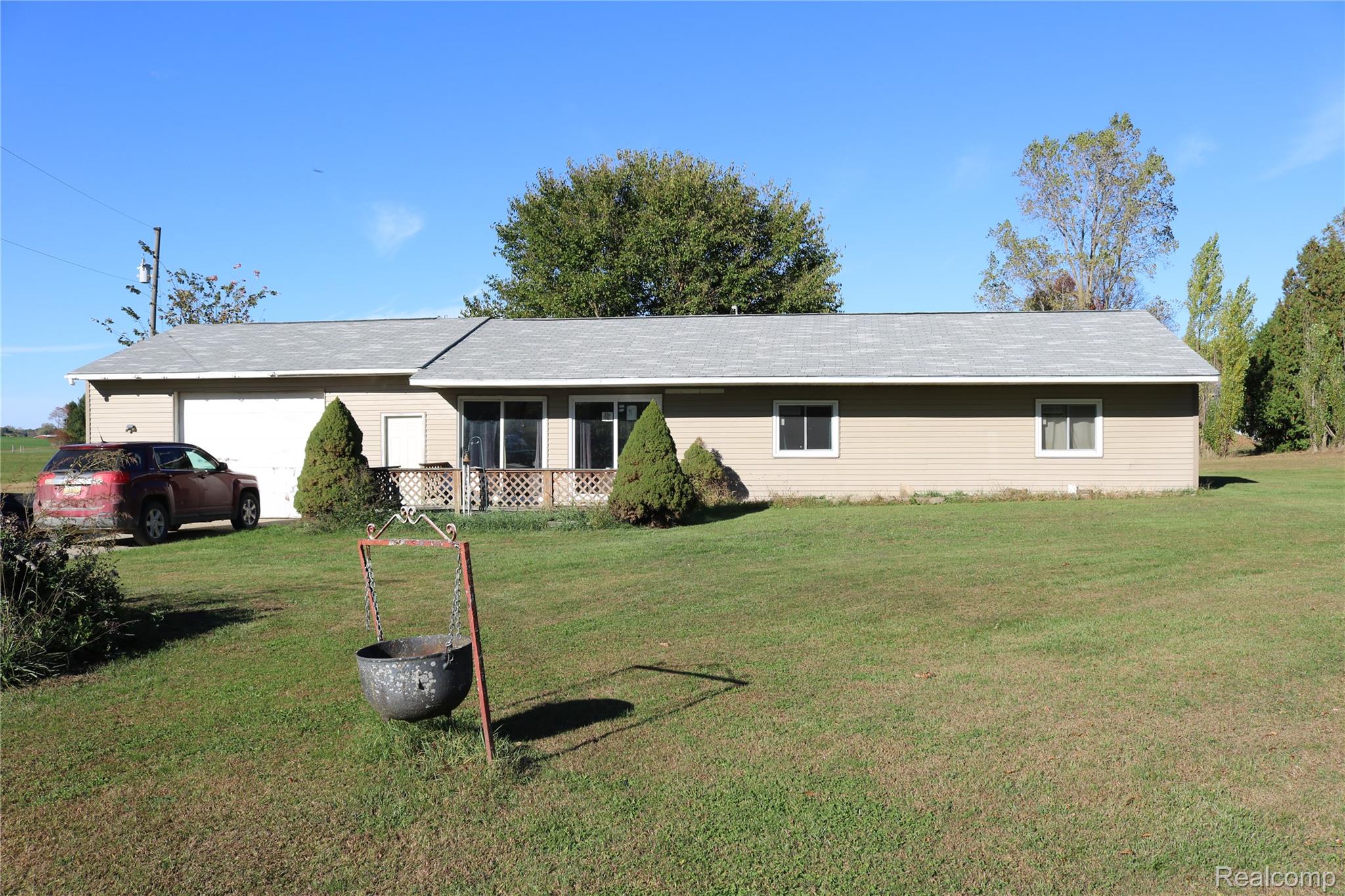 Ranch-style home with a front yard and an attached garage