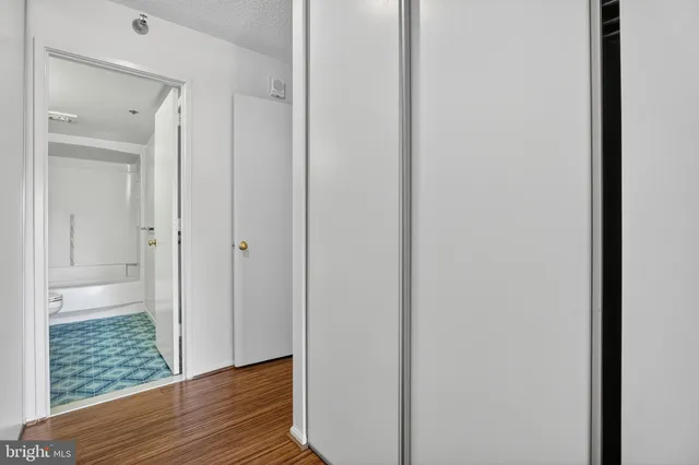 a view of a hallway with wooden floor