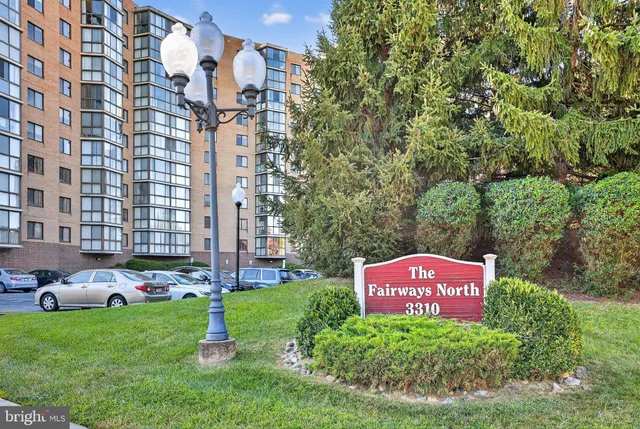 a sign board with a building in the background