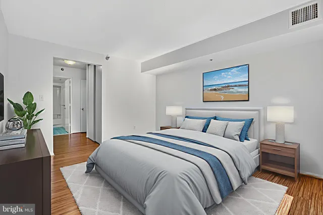 a bedroom with a bed and a potted plant