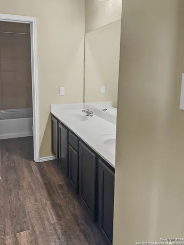 a bathroom with a double vanity sink and a mirror