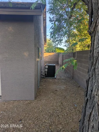 a view of a house with backyard and wooden fence