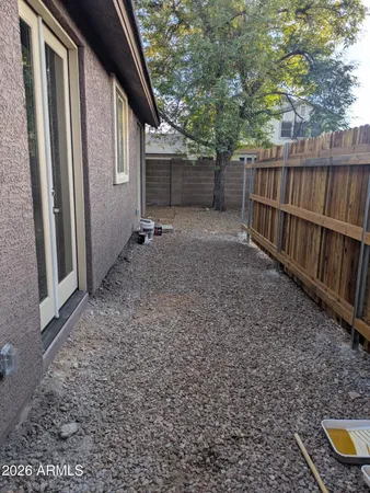 a kitchen with granite countertop a stove a sink and a refrigerator