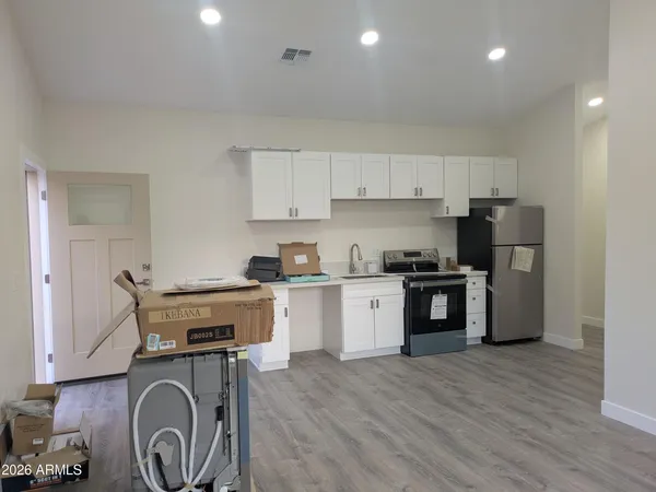 a kitchen with stainless steel appliances granite countertop a stove and a sink