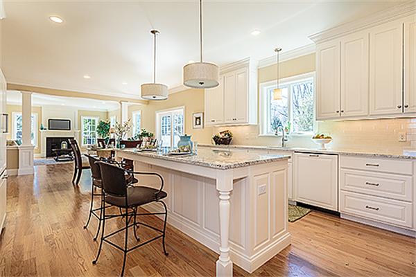 28 Robinson Road Lexington, MA 02420 - Photo 5 of 11 a kitchen with stainless steel appliances granite countertop a stove a sink dishwasher a dining table and chairs with wooden floor