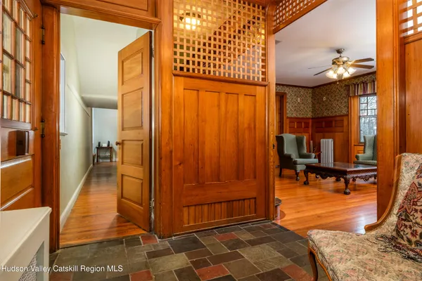a living room with furniture a fireplace and wooden floor