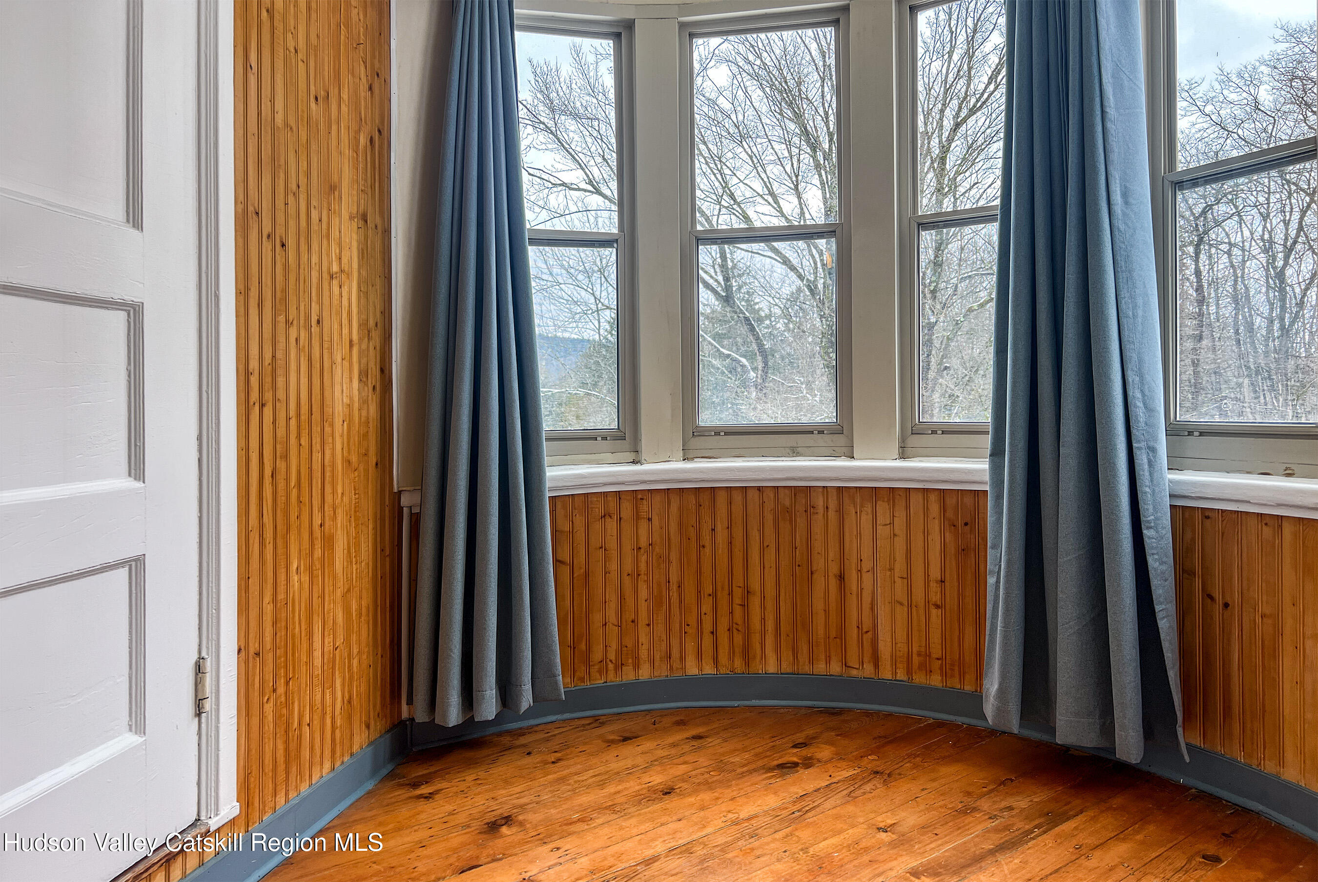 6 Westridge Road Cooperstown, NY 13326 - Photo 50 of 109 a view of an empty room with wooden floor and a window